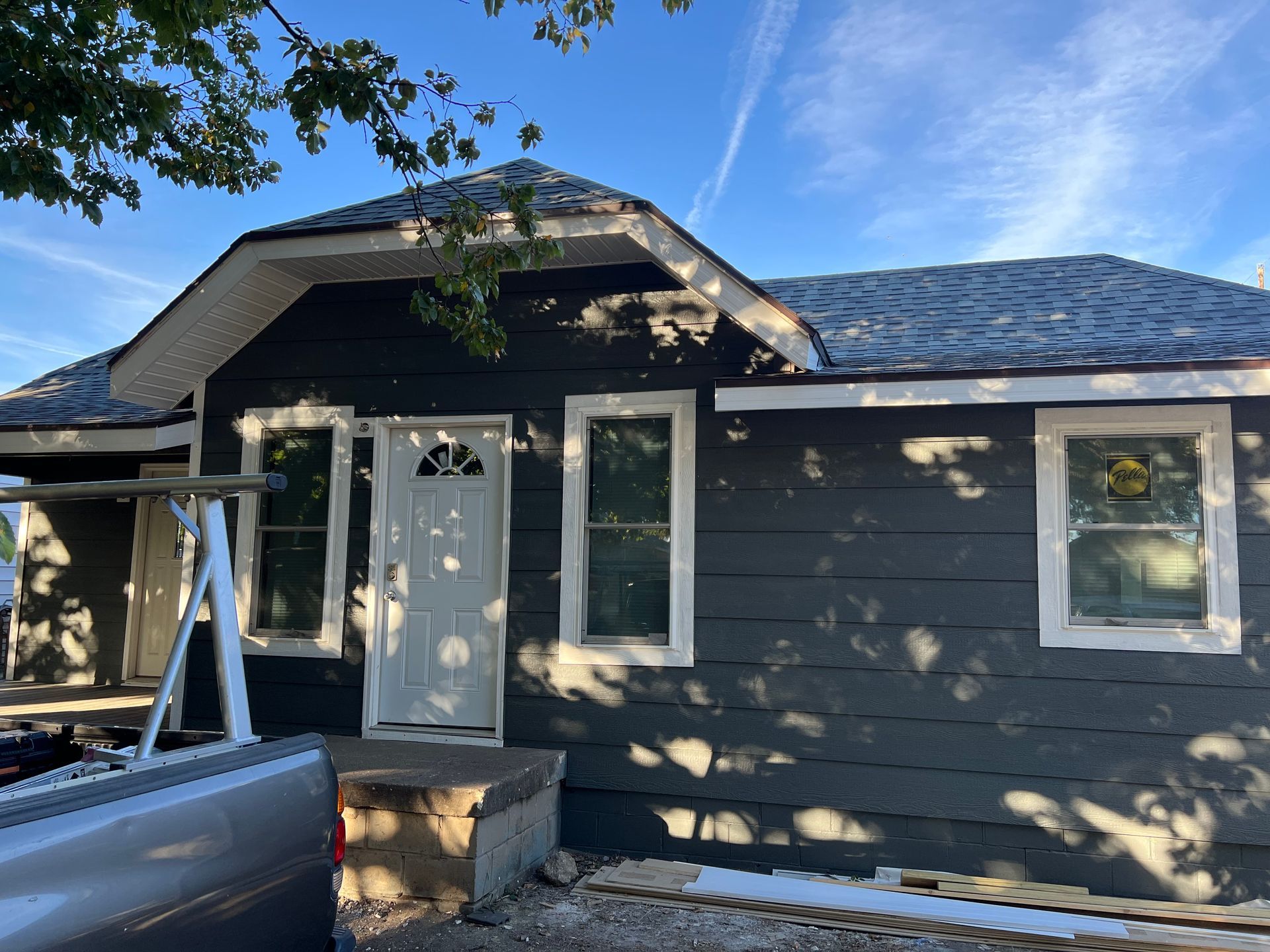 A truck is parked in front of a house under construction.