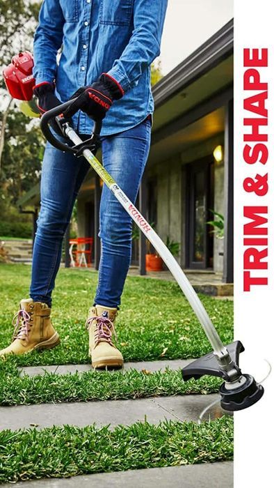 A Person Is Using A Lawn Mower To Trim The Grass — Ken Matthews Auto & Mower Centre In Ulladulla, NSW