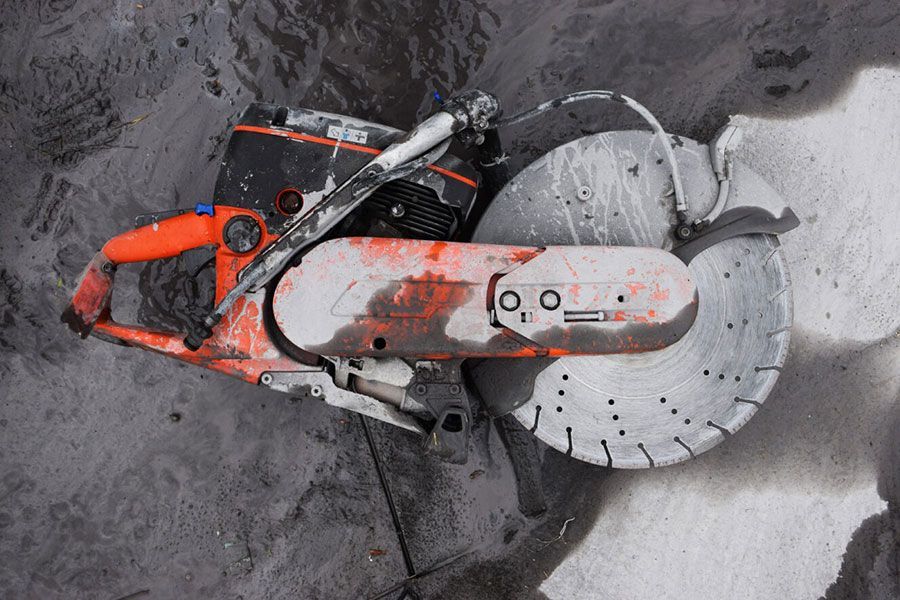 A Circular Saw Is Sitting On A Concrete Surface — Ken Matthews Auto & Mower Centre In Ulladulla, NSW
