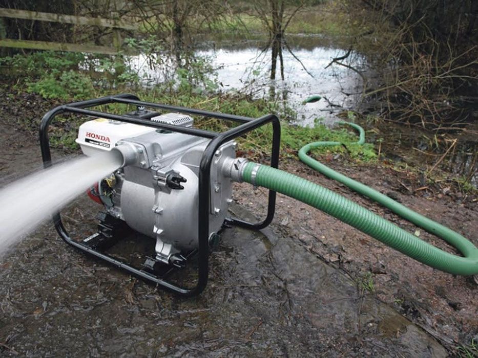 A Water Pump With A Green Hose Attached To It — Ken Matthews Auto & Mower Centre In Ulladulla, NSW