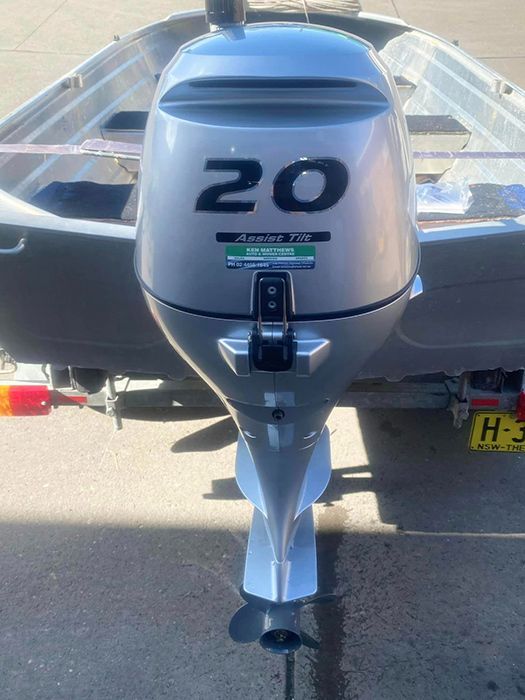 A Boat With A 20 Hp Outboard Motor Is Parked On The Side Of The Road — Ken Matthews Auto & Mower Centre In Ulladulla, NSW