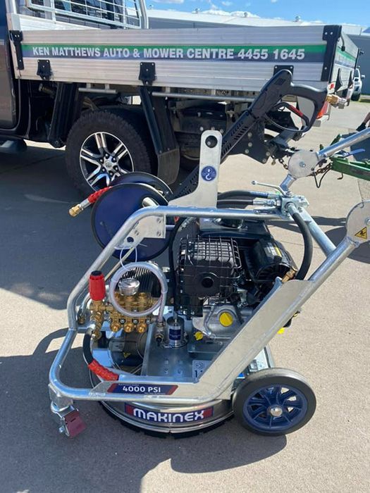 A Machine Is Parked In Front Of A Truck — Ken Matthews Auto & Mower Centre In Ulladulla, NSW