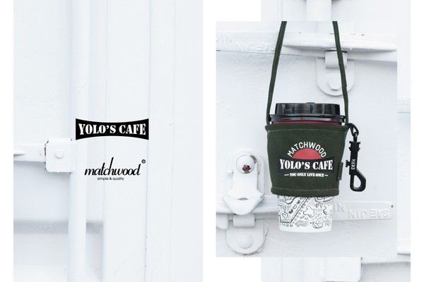 A coffee cup holder is attached to a white wall.