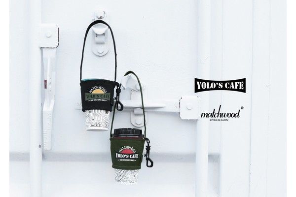 Two coffee cup holders are hanging on a white wall.