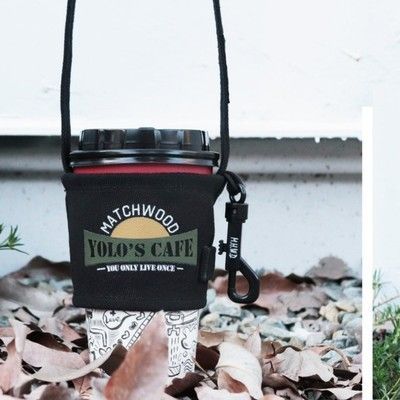 A cup holder that says hatchwood yolo 's cafe on it