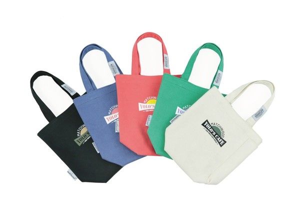 A group of sesame street tote bags are stacked on top of each other