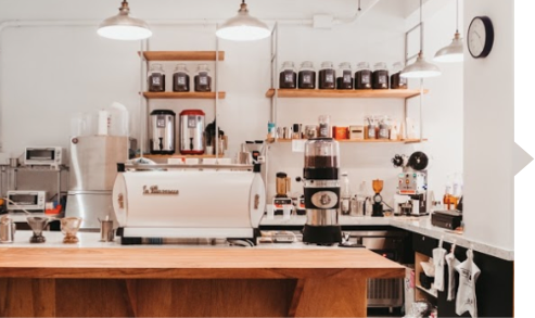 A kitchen with a wooden table and a coffee machine.