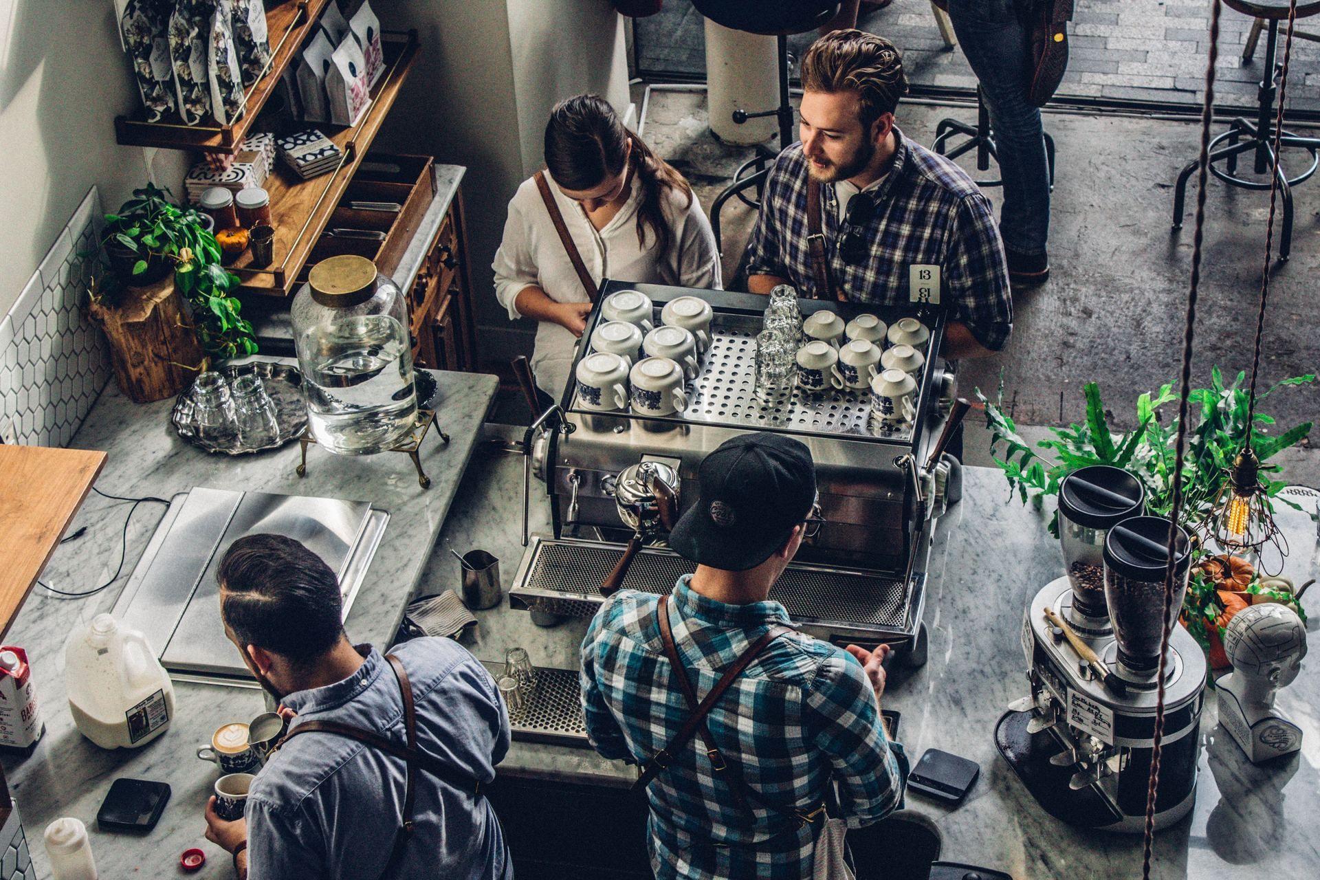 A group of people are sitting at a counter in a coffee shop.