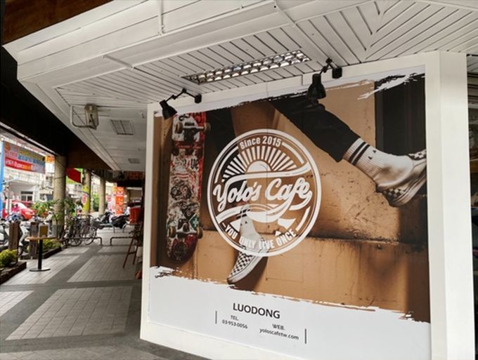 A sign for a cafe with a picture of a person on a skateboard.