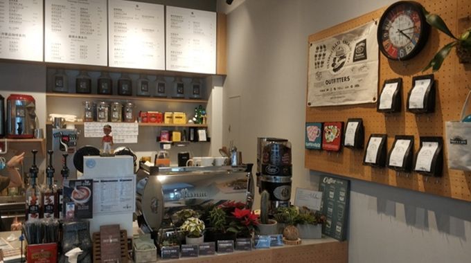 The inside of a coffee shop with a clock on the wall.