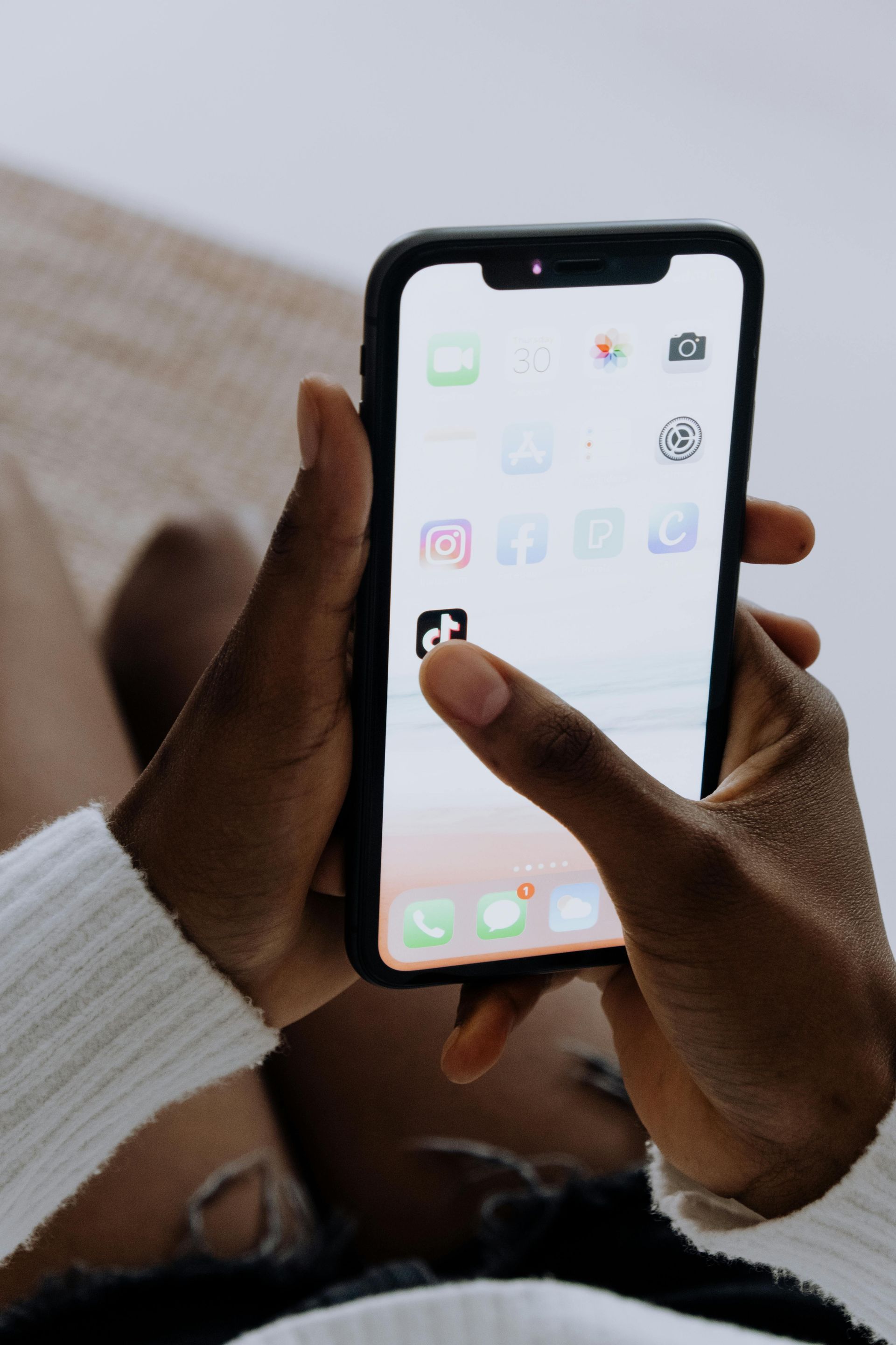 A person is holding a cell phone in their hands.