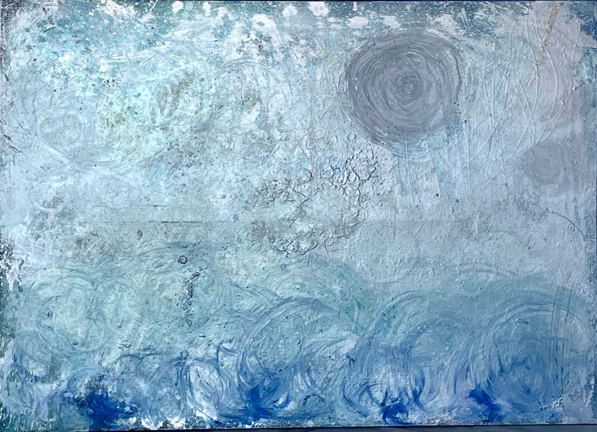 A blue and white painting with a swirl in the middle