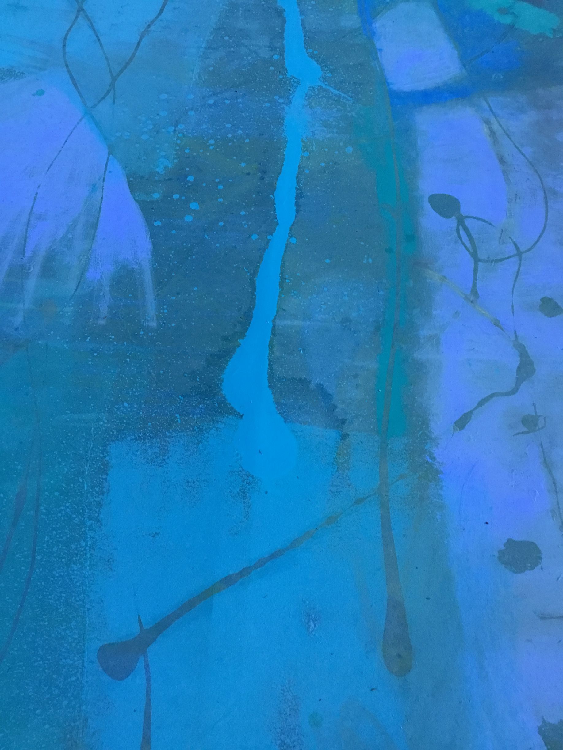 A close up of a blue and green painting on a wall.