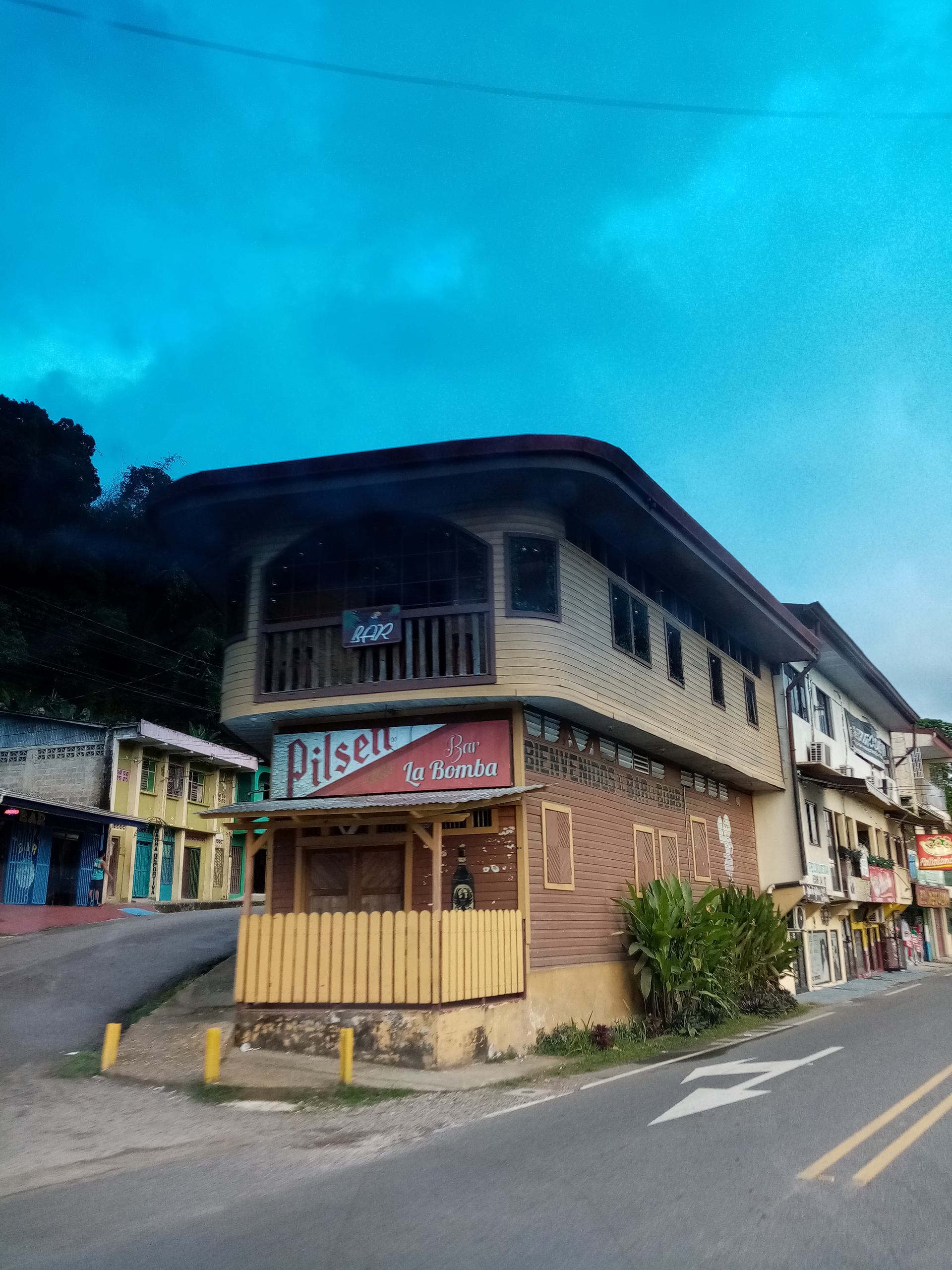 Building with a balcony, street view. A restaurant sign 