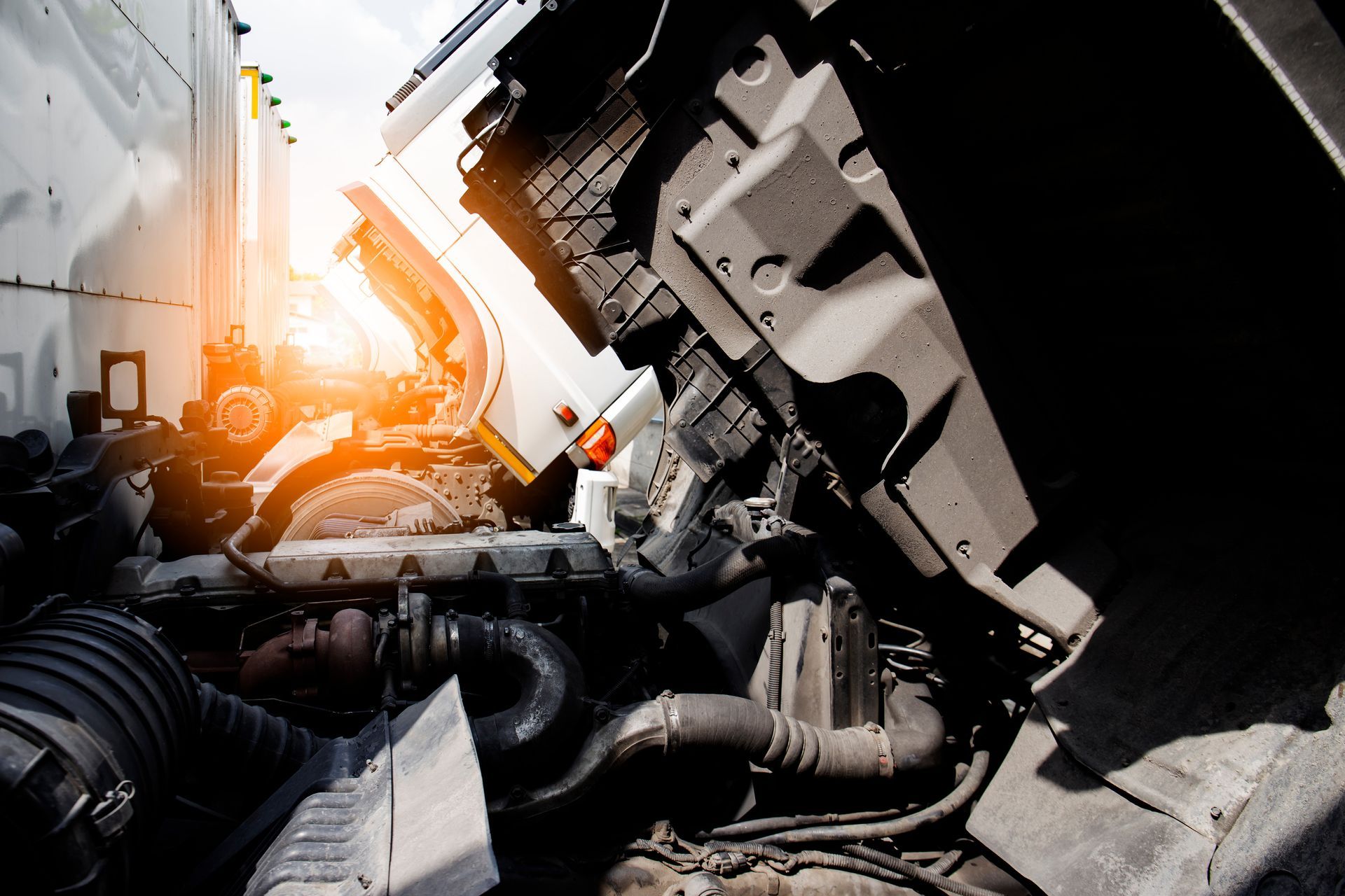 The engine of a semi truck is shown with the hood open.