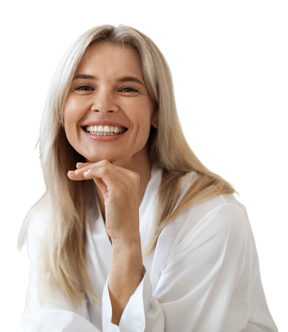 A woman in a white shirt is smiling with her hand on her chin.