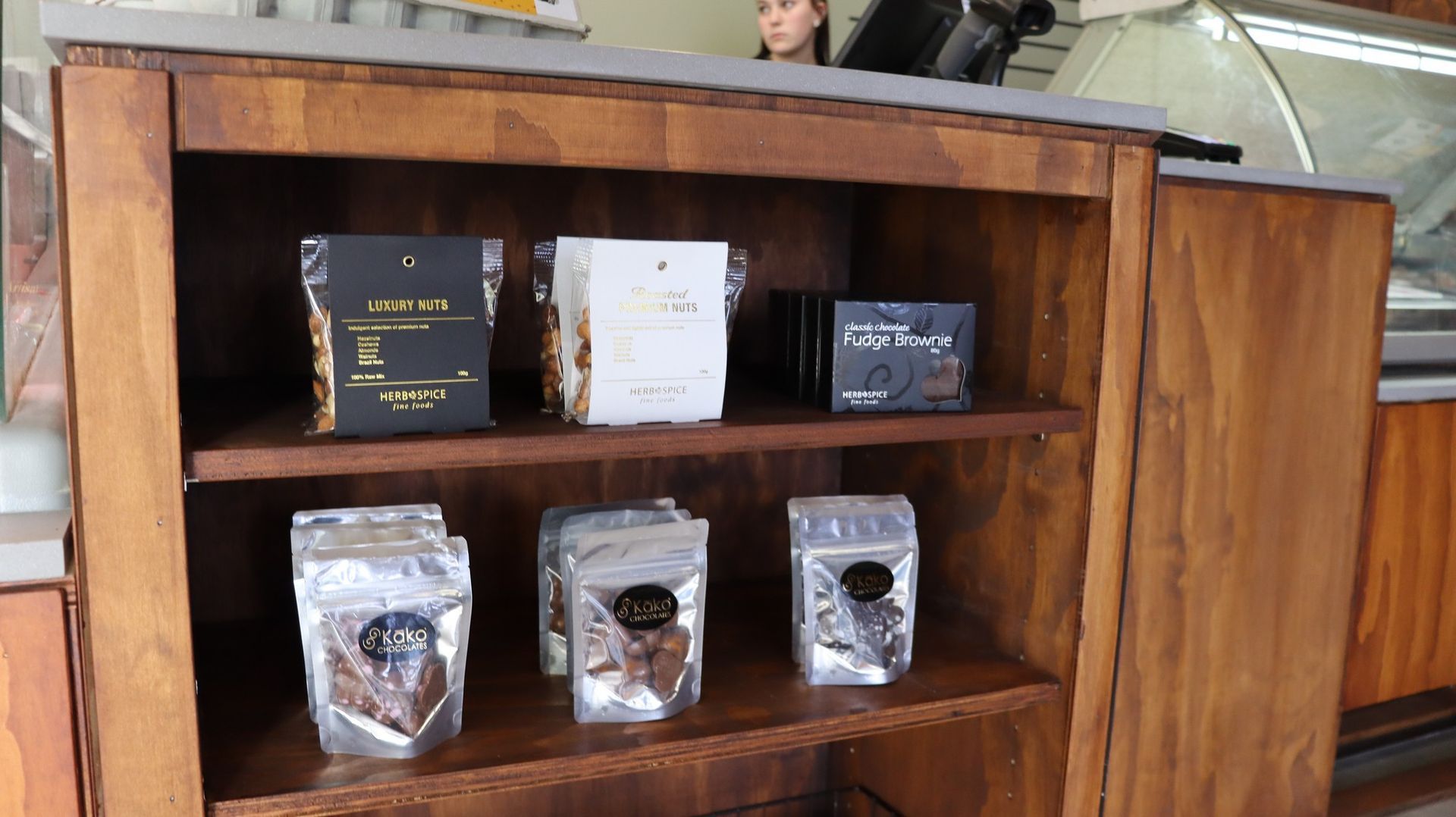 A wooden shelf with bags of food on it