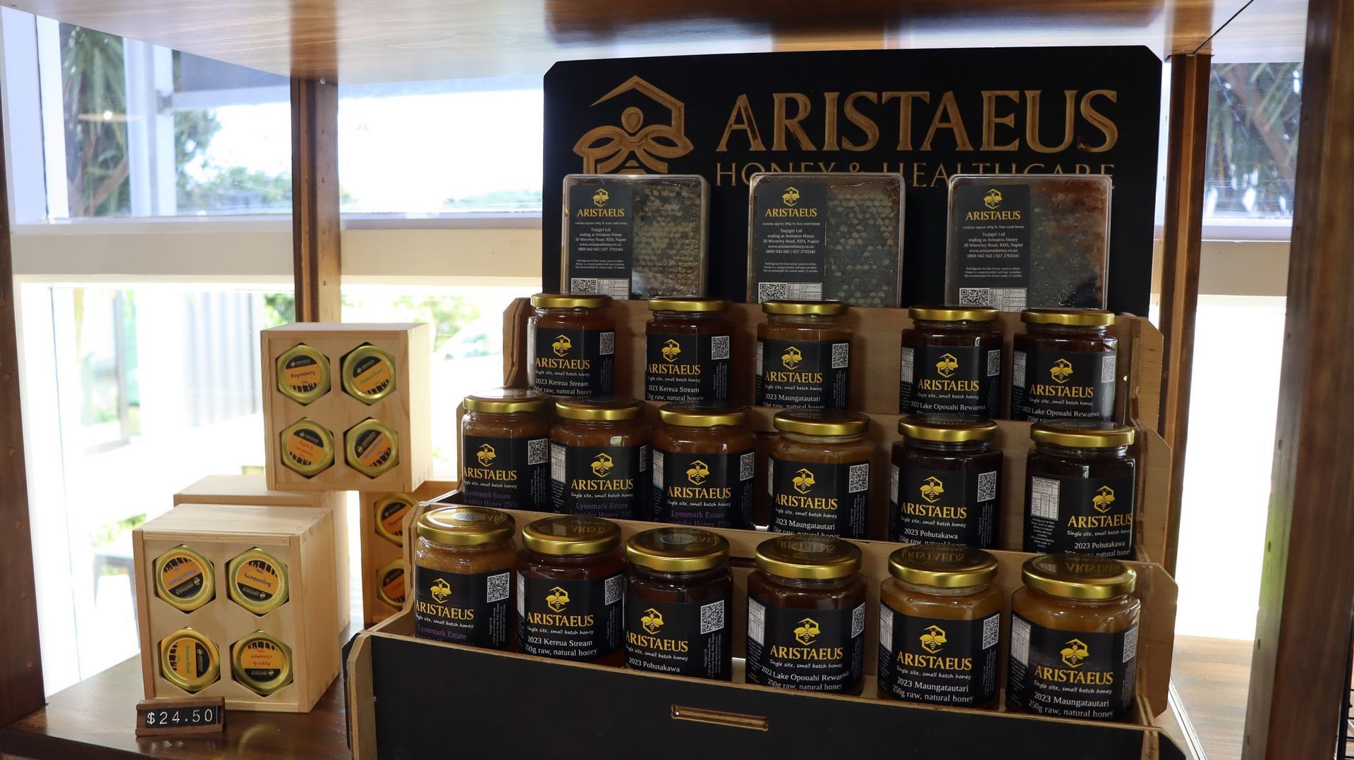 A display of jars of aristaeus honey on a shelf