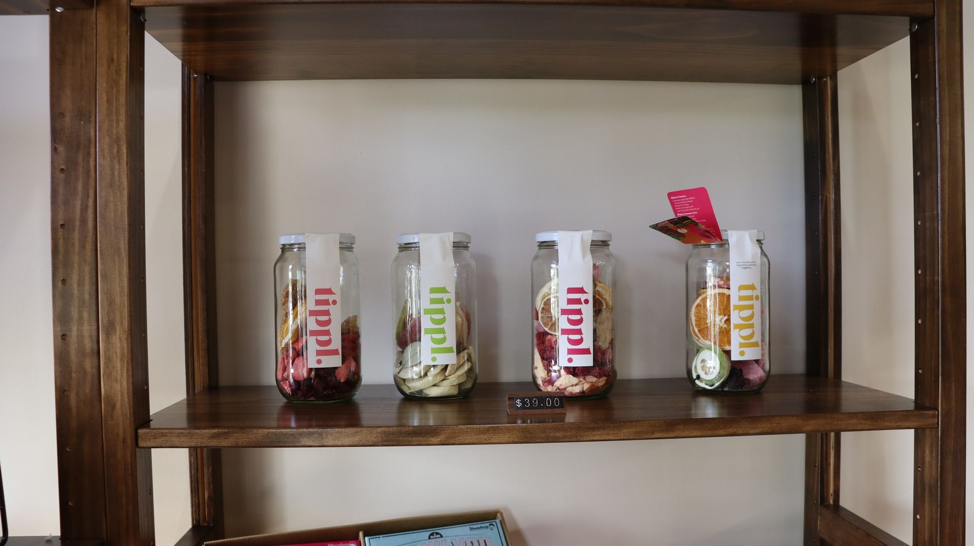 A wooden shelf with jars of food on it