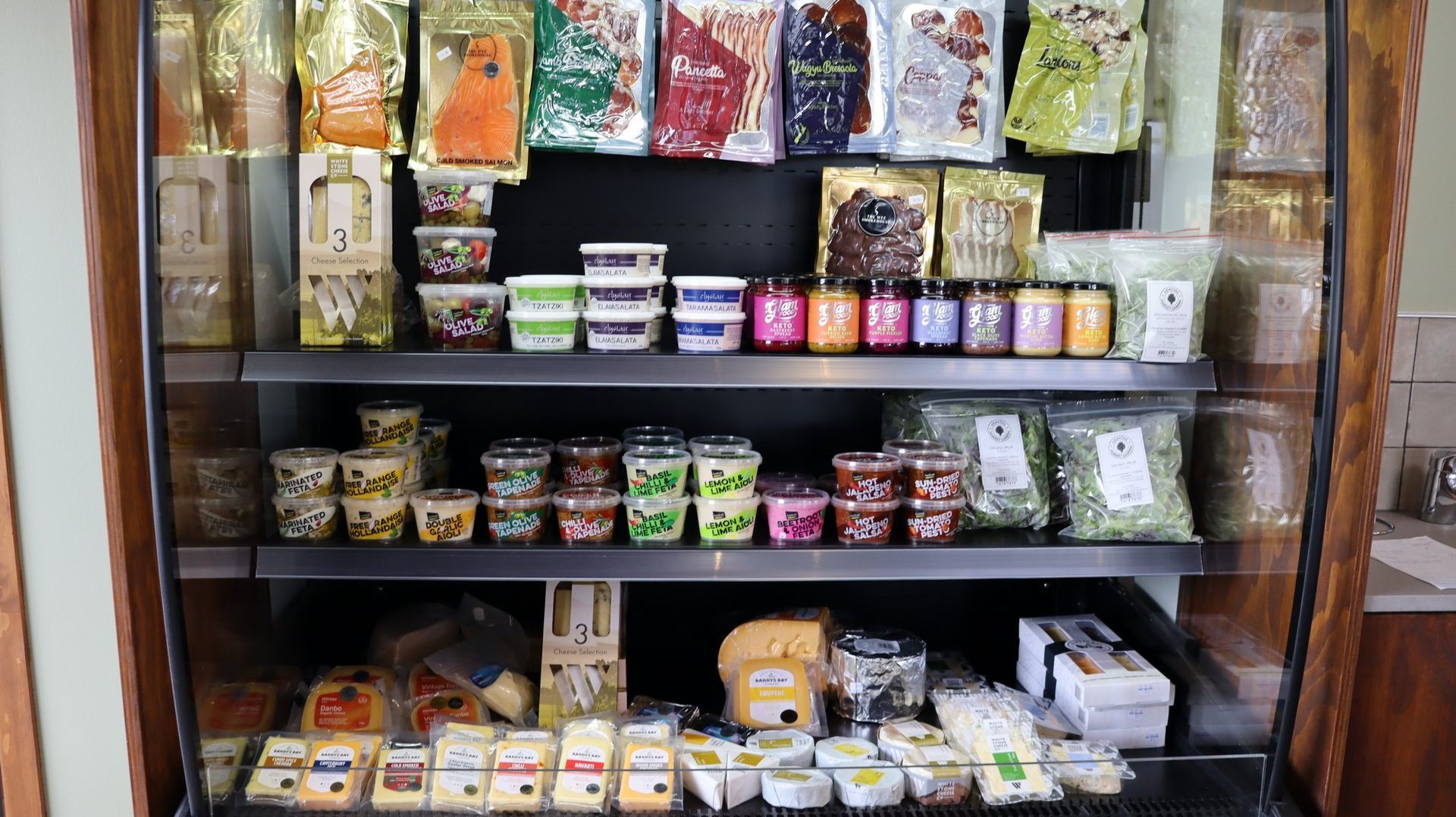 A refrigerator filled with lots of different types of food.