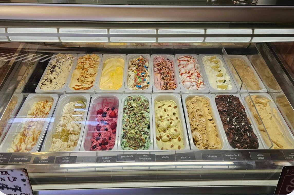 A display case filled with lots of different flavors of gelato.