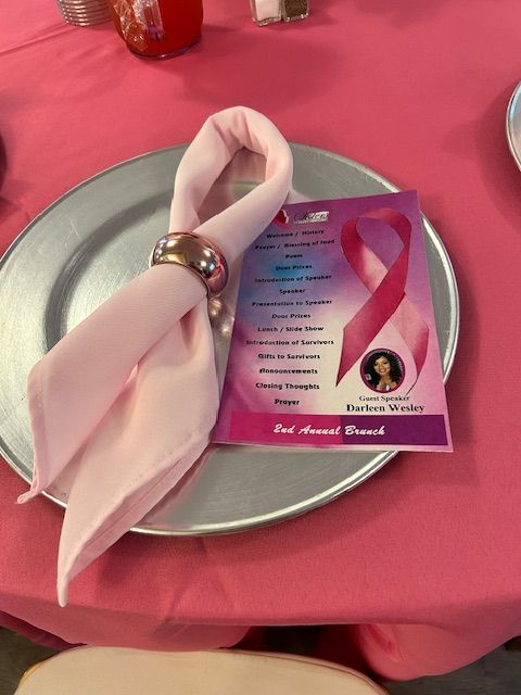 A silver plate with a pink napkin on it