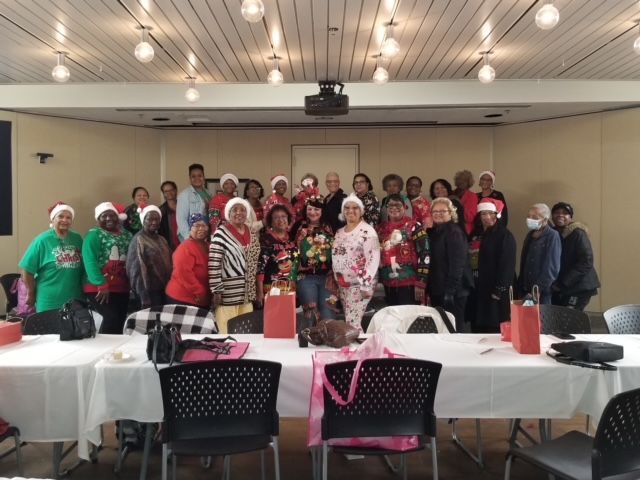 A group of people wearing santa hats are posing for a picture