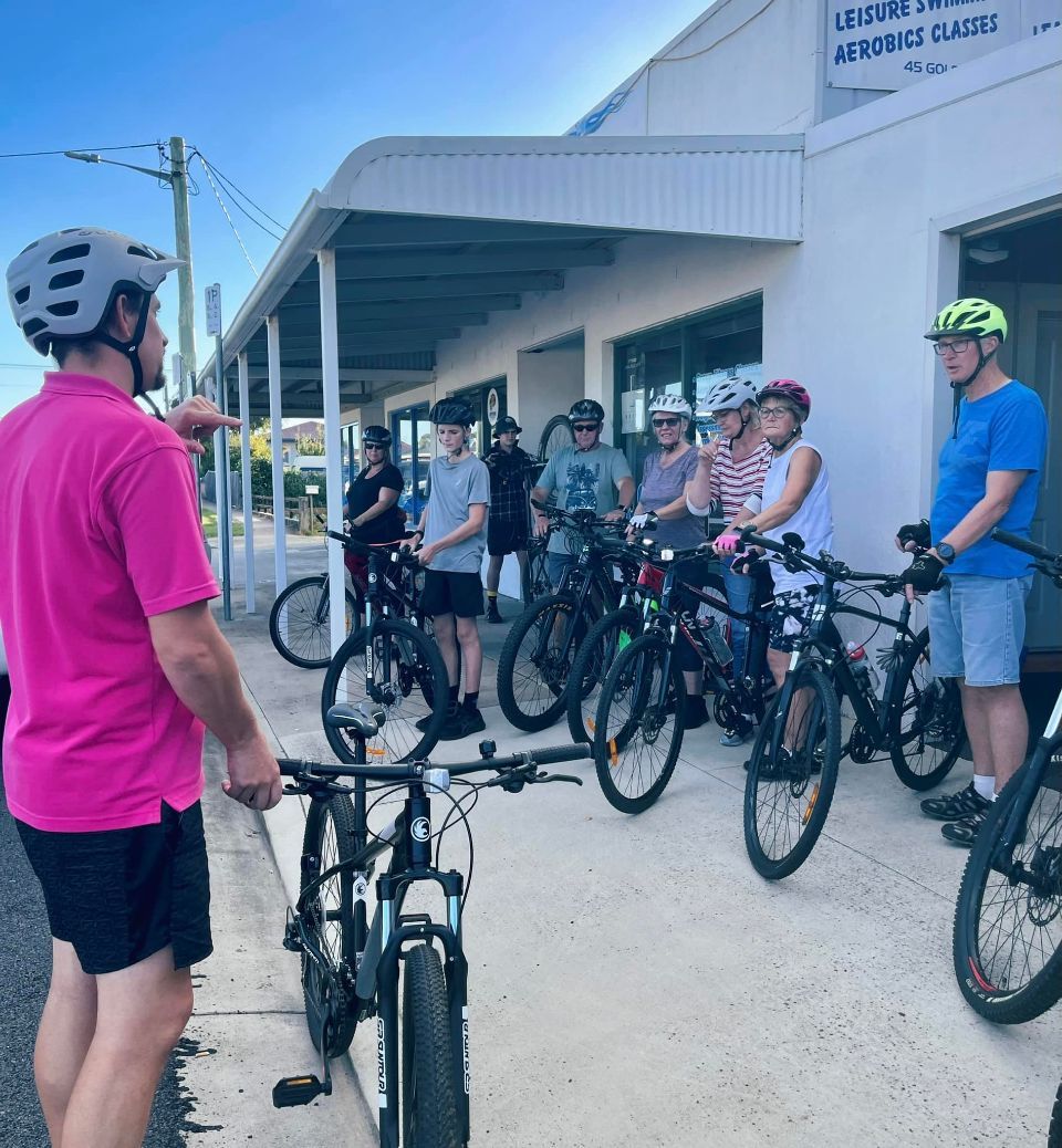 Man giving instructions to cyclists.