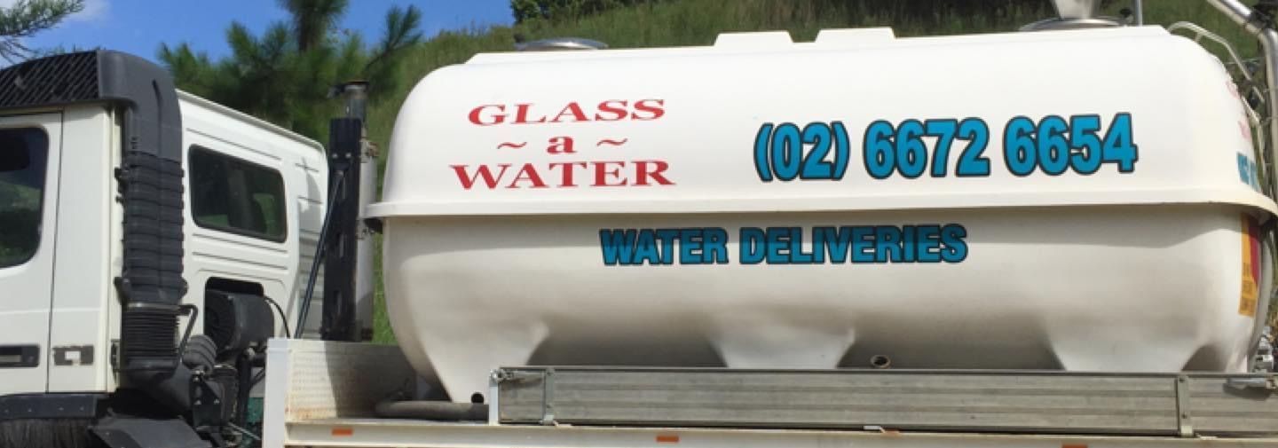 A white truck with the words glass water on it