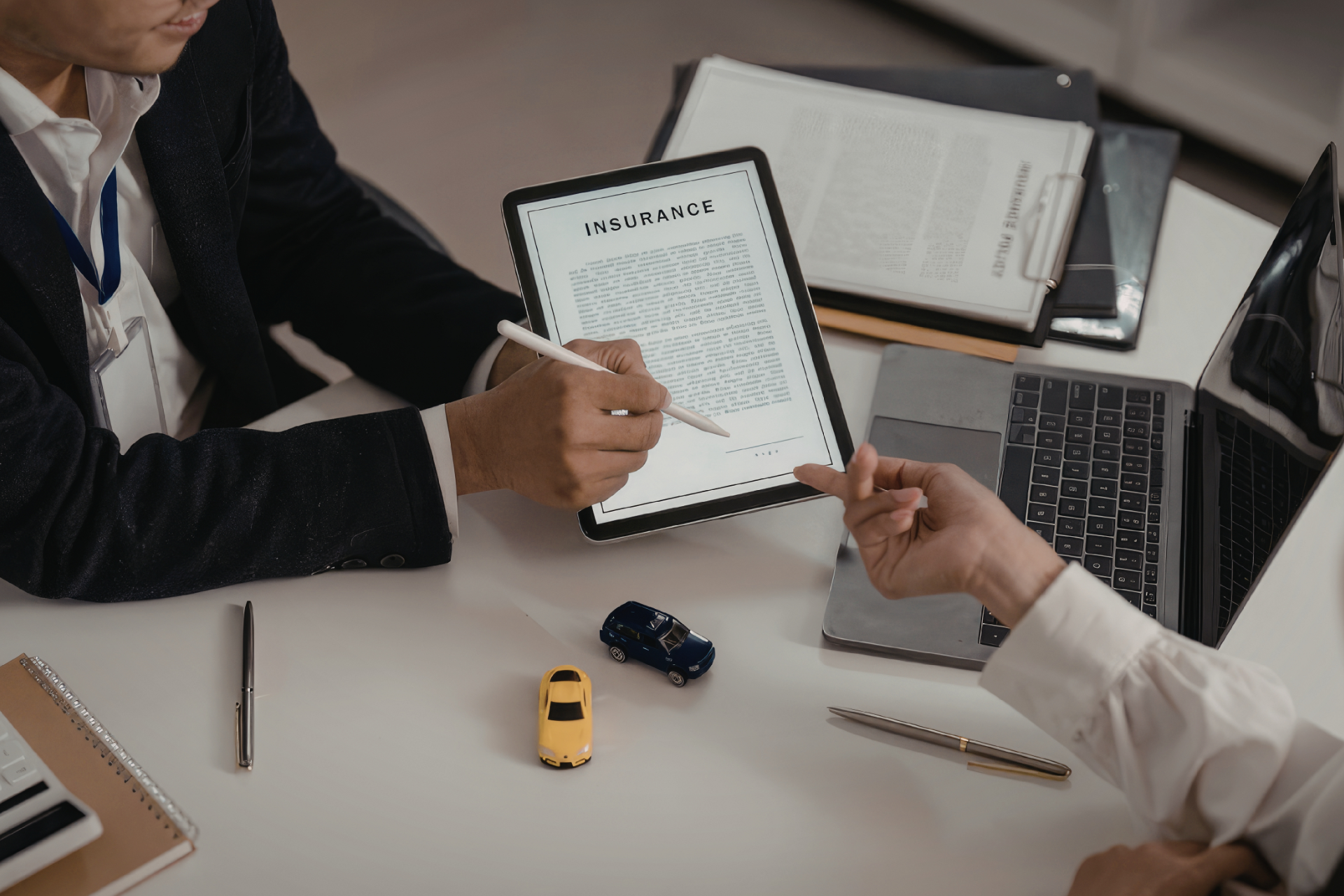Semi-truck and trailer crashed off road. People stand near wreckage, green field, blue sky.