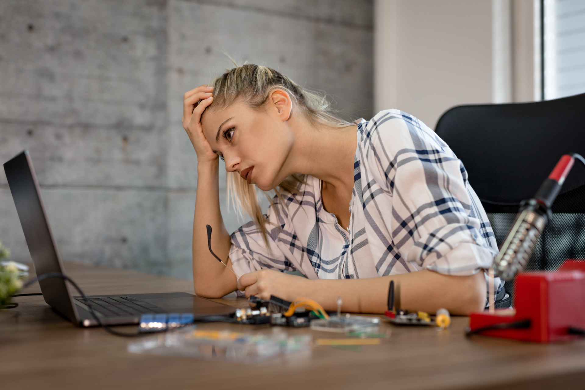 Semi-truck and trailer crashed off road. People stand near wreckage, green field, blue sky.