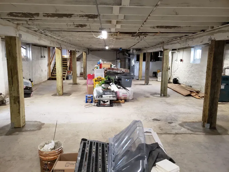 A basement filled with lots of boxes and tools.