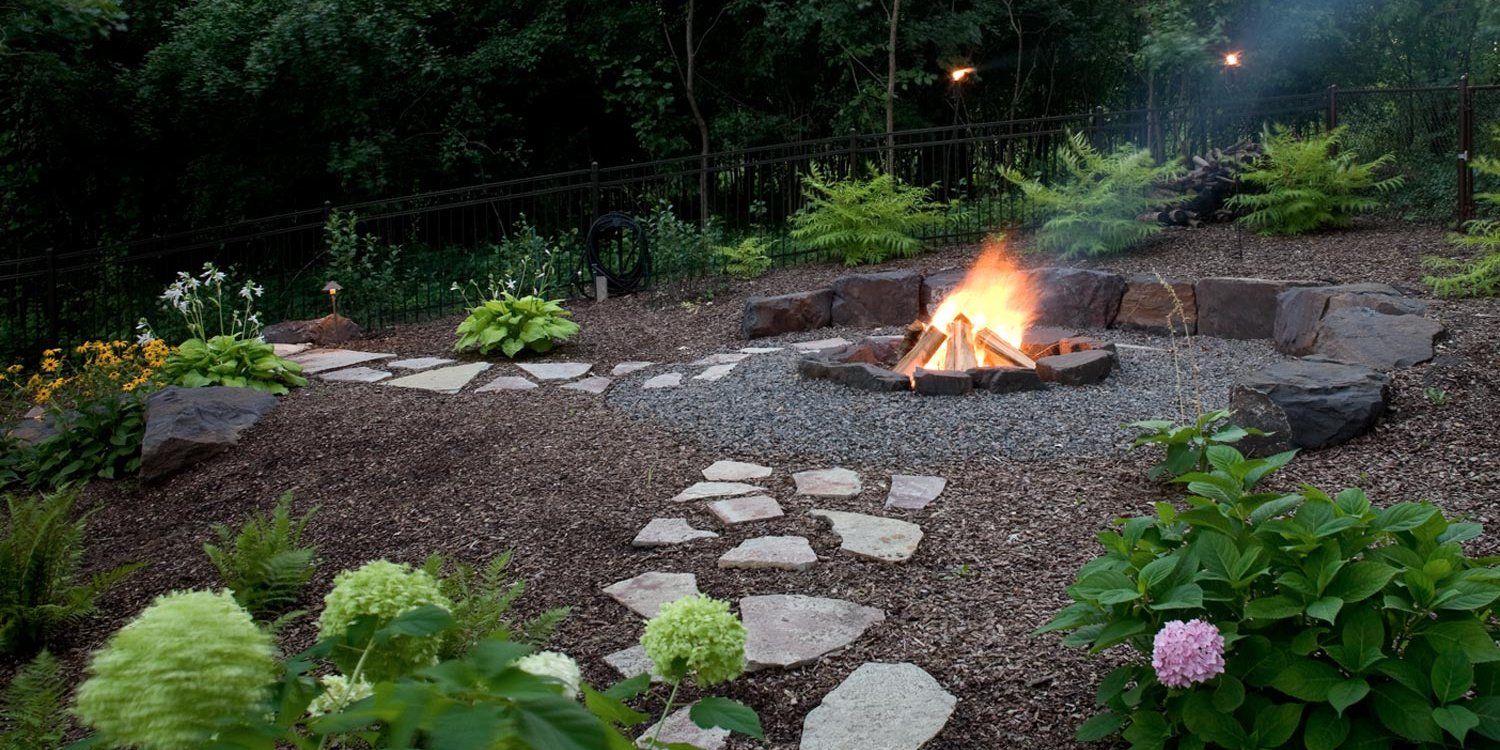 There is a fire pit in the middle of the garden.