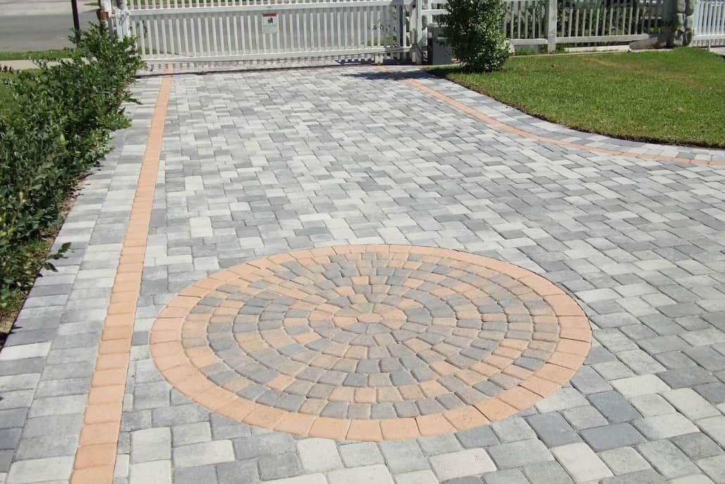 A driveway with a circular design in the middle