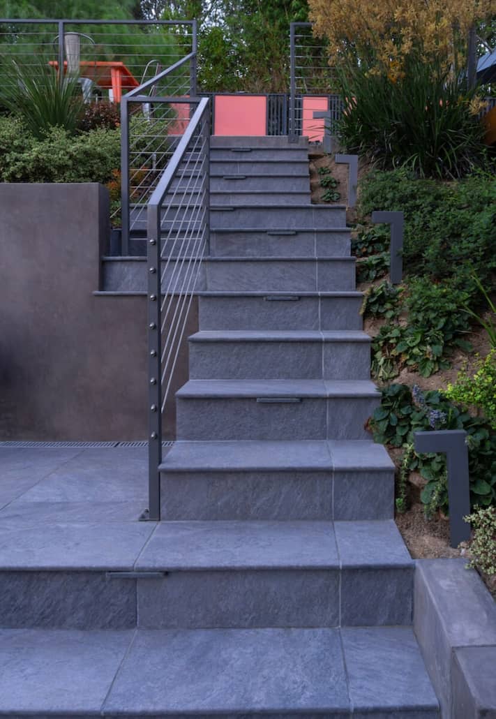 A set of stairs with a metal railing and a sign that says ' e ' on it
