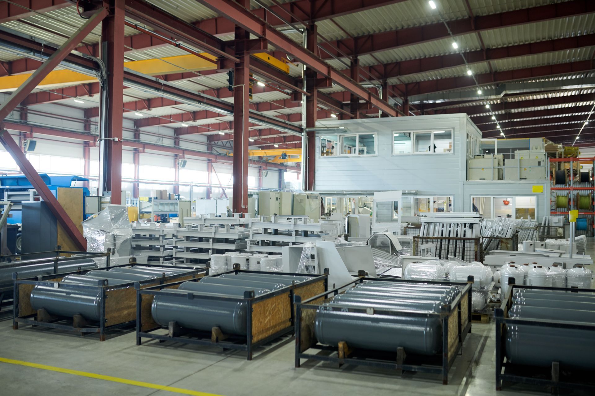 A large warehouse filled with lots of metal cylinders.