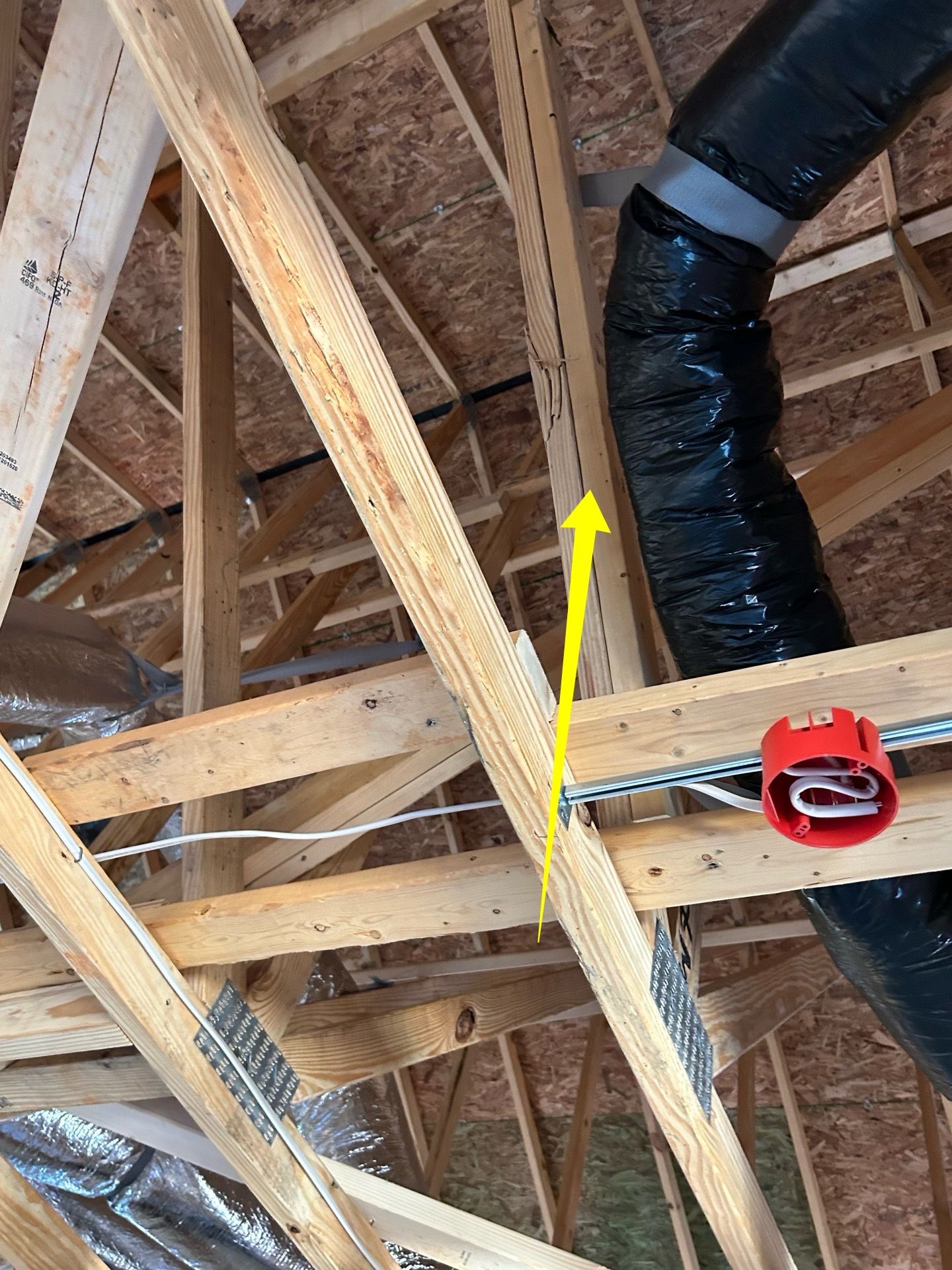 A picture of a ceiling with a yellow arrow pointing to a duct.
