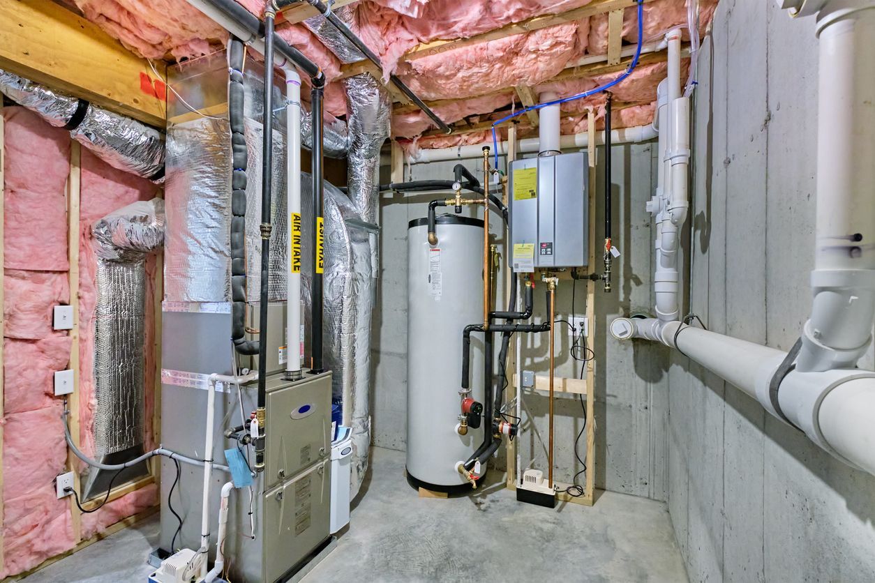 A basement with a lot of pipes and appliances.