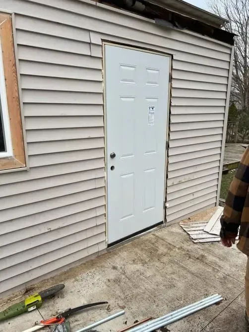 Bathroom remodel: White tiled walls with a dark mosaic band. Bathtub and niche with blue-gray accent tiles.