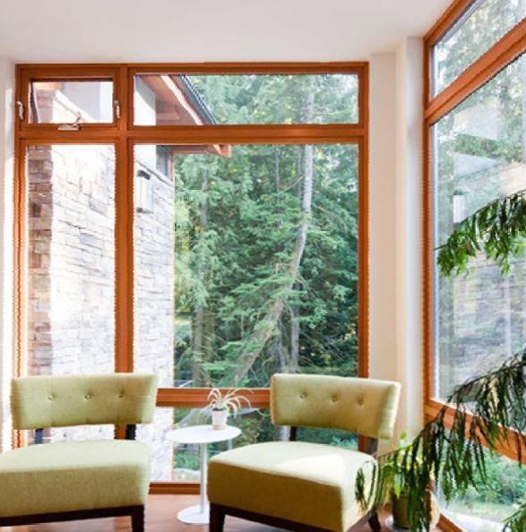 A living room with two green chairs and a plant