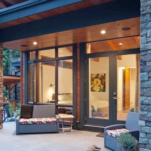 A patio with a couch and chairs in front of a bedroom