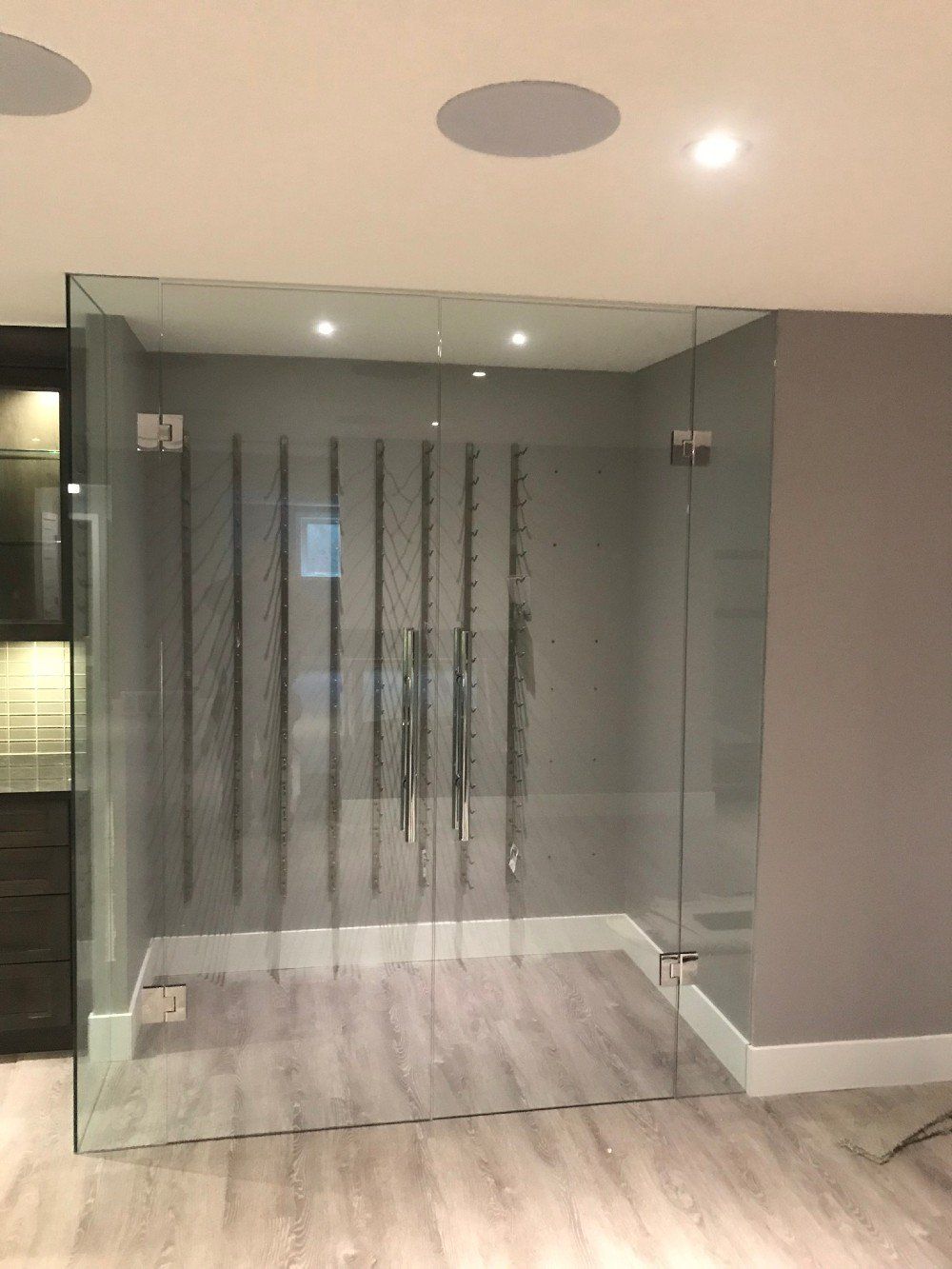 A room with a glass wall and sliding glass doors.