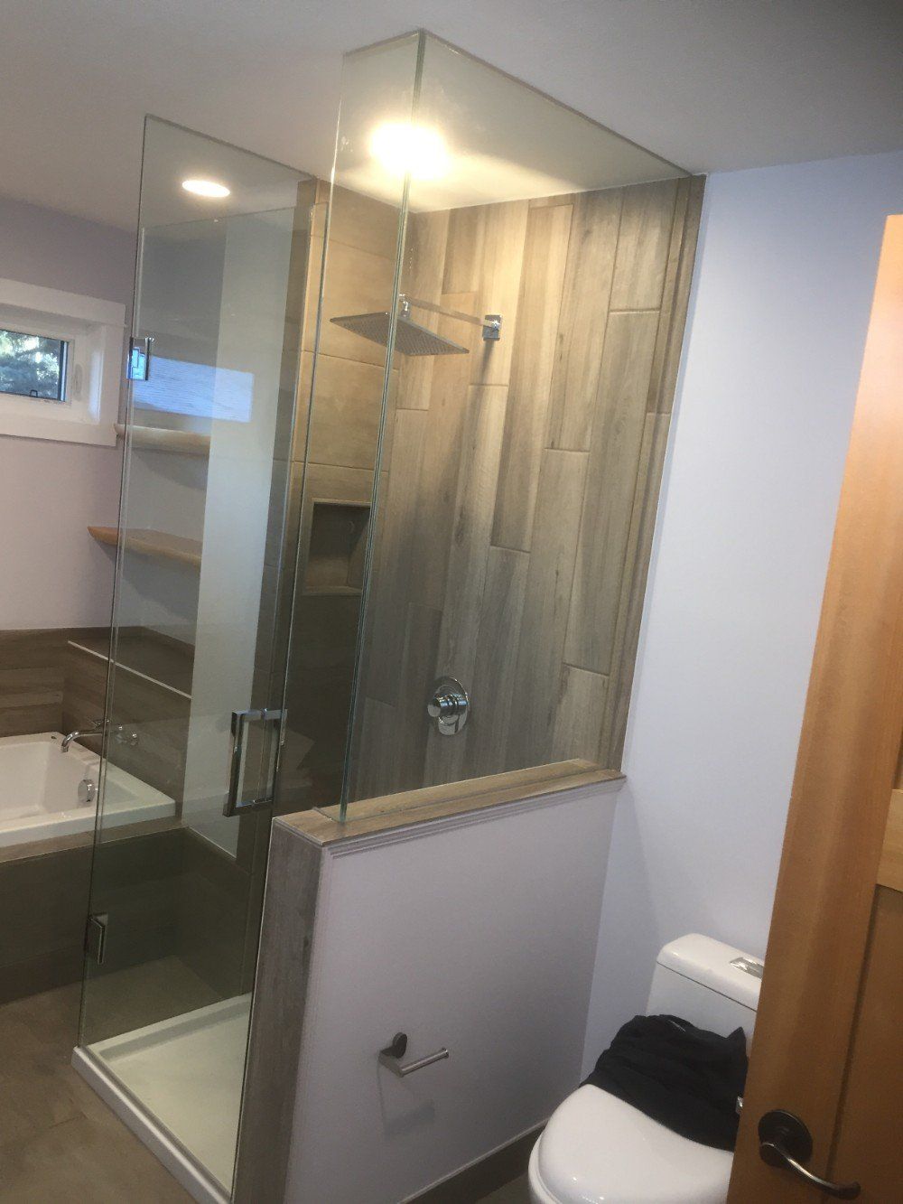 A bathroom with a walk in shower and a toilet.