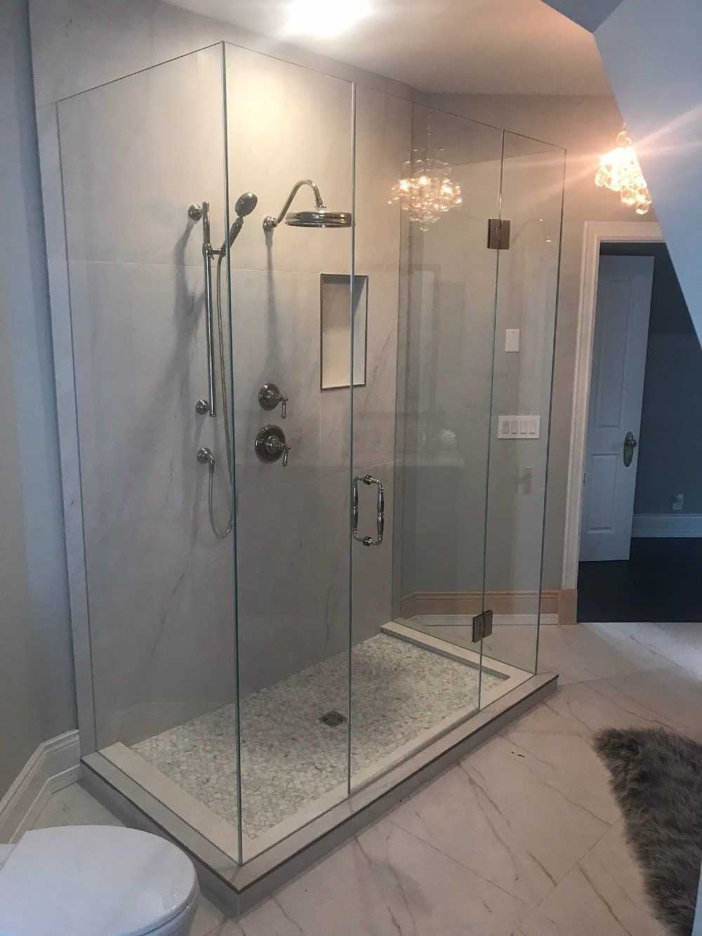 A bathroom with a walk in shower and a toilet.