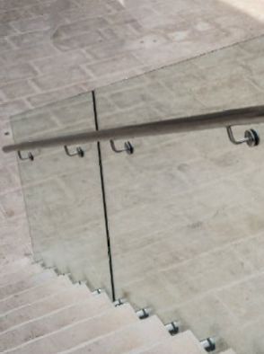 A close up of a glass railing on a set of stairs