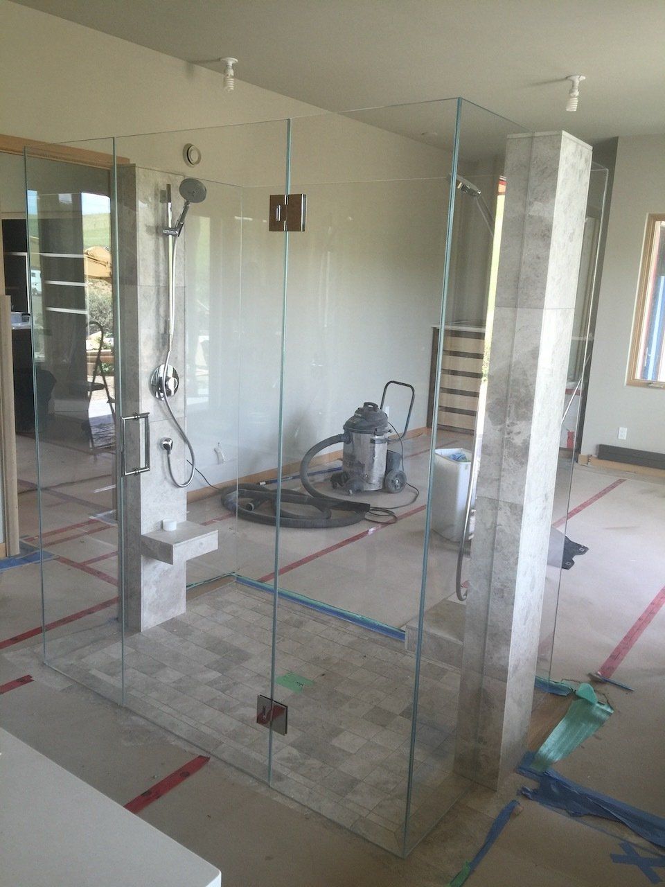 A bathroom under construction with a vacuum cleaner on the floor