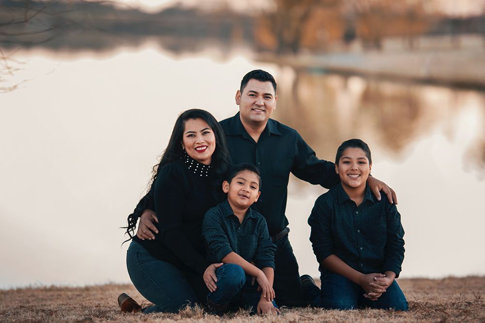 Hispanic family father, mother, and two children enjoying each others company