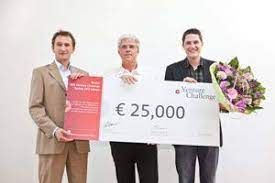 Three men are holding a large cheque and a bouquet of flowers.