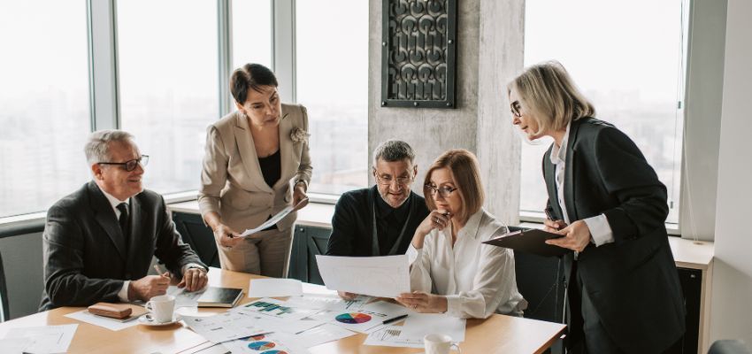 Professionals work together to gain knowledge about the tax benefits of a corporation.