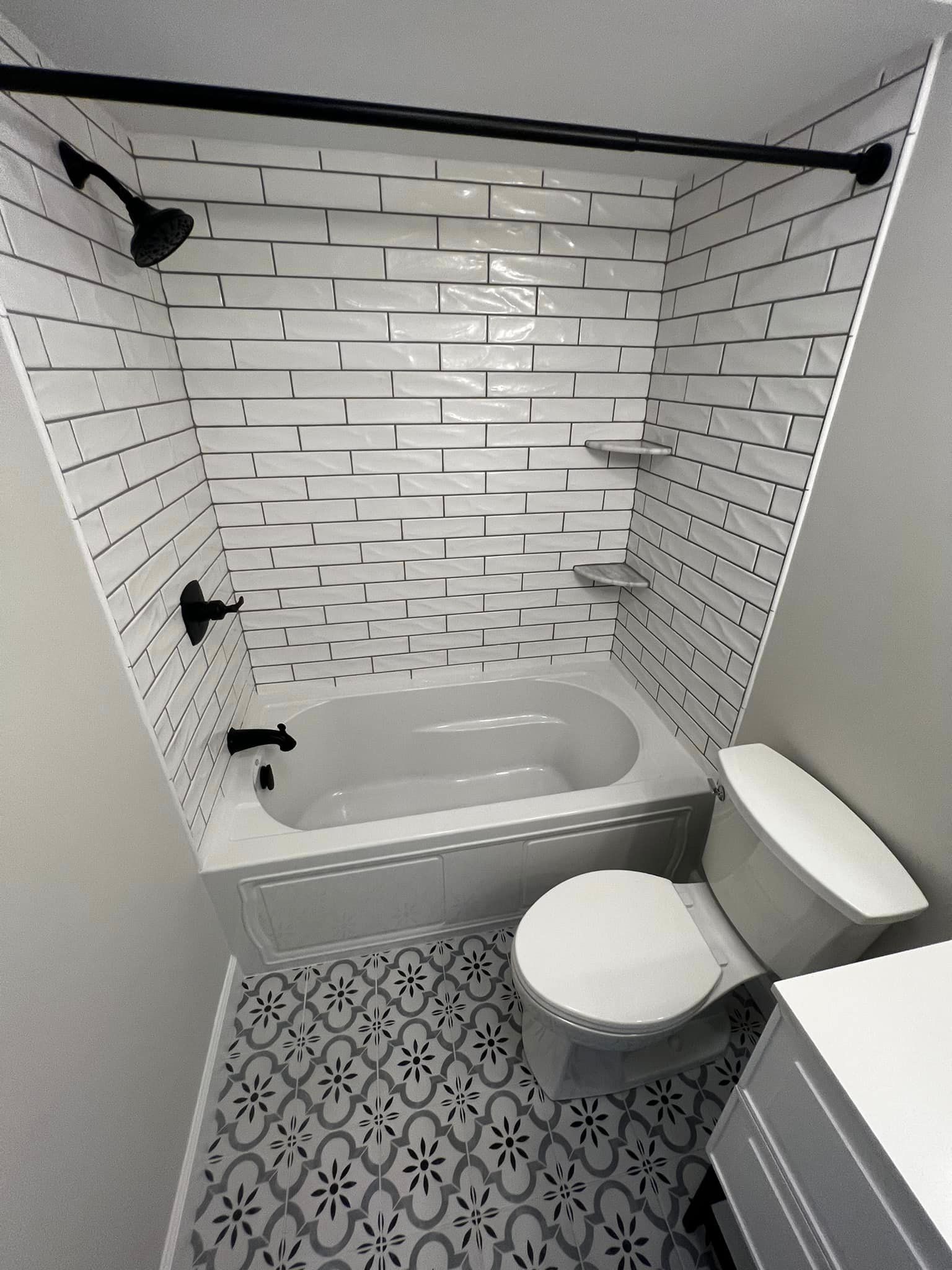 A bathroom with a bathtub , toilet , and shower.